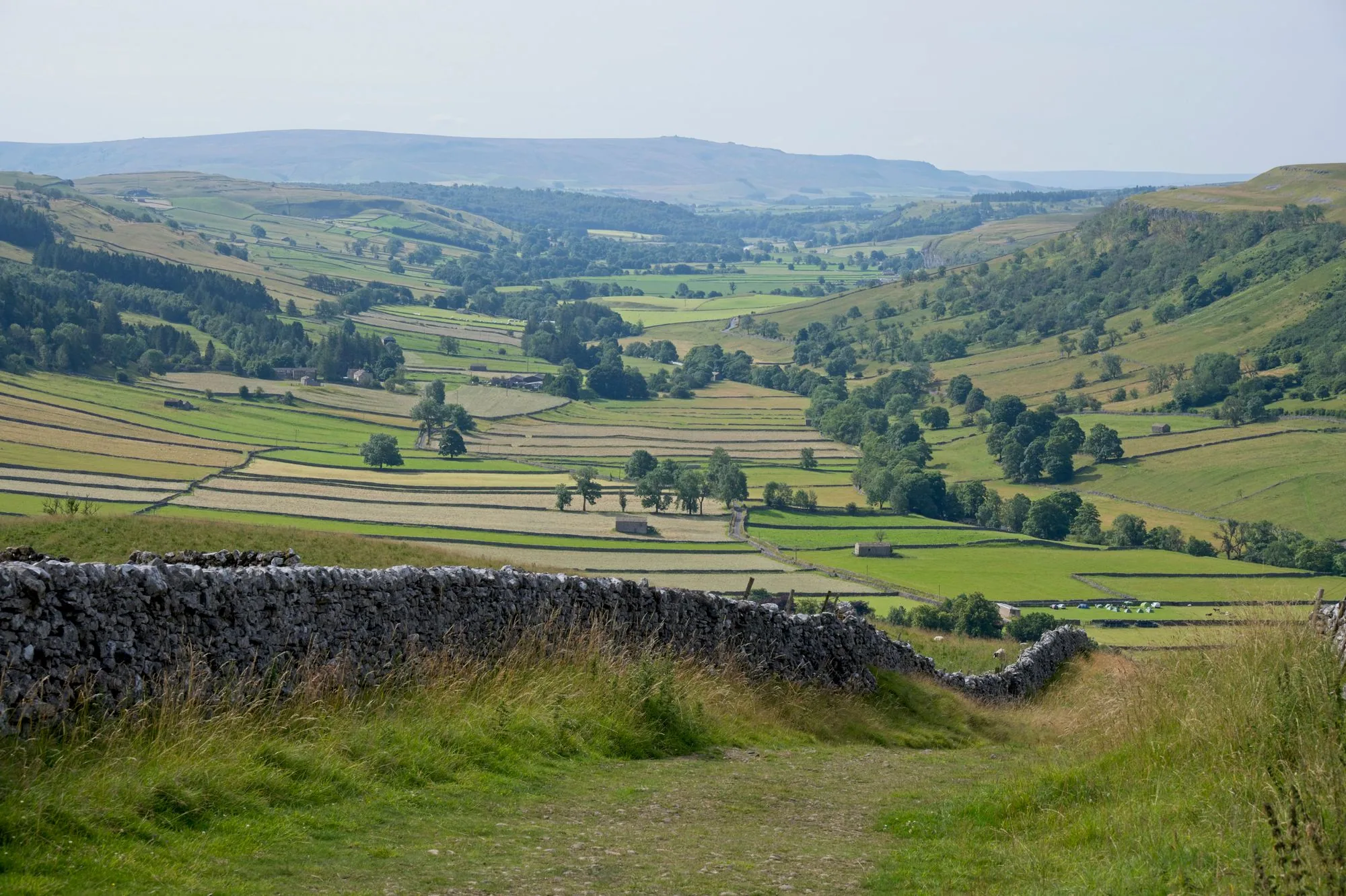 Breathtaking view of rolling hills and fields in England's picturesque countryside.