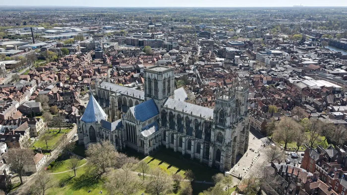 Aerial view of York Minster with surrounding cityscape, captured on a sunny day.