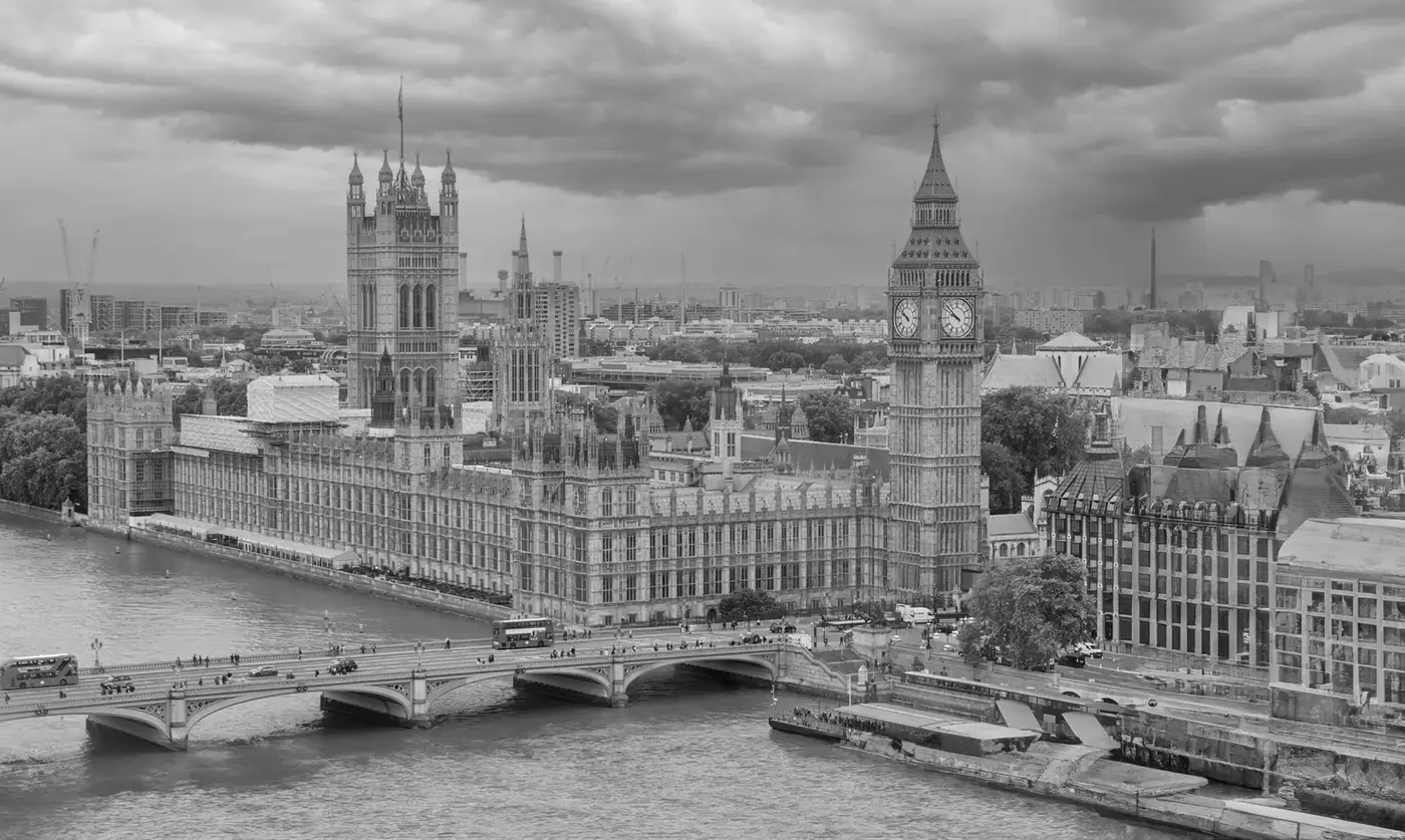 Monochrome aerial view of Big Ben and the Houses of Parliament over the River Thames in London.