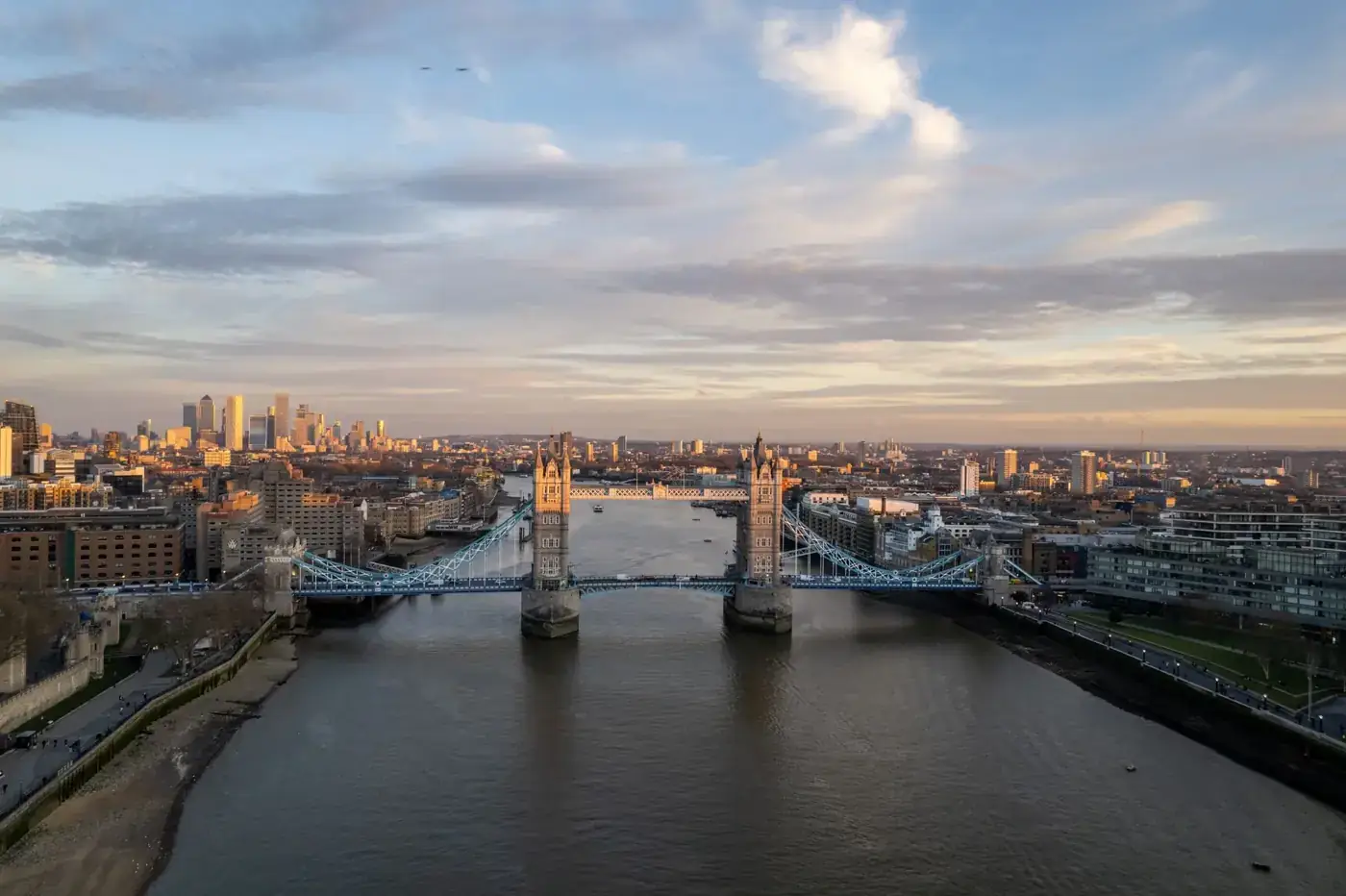 A breathtaking aerial shot of London's Tower Bridge with the city skyline at dusk.