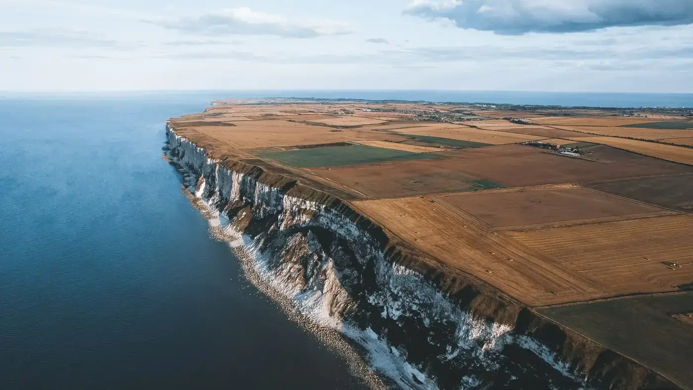 A breathtaking aerial view of the scenic coastline and farmland in Kingston upon Hull, England.