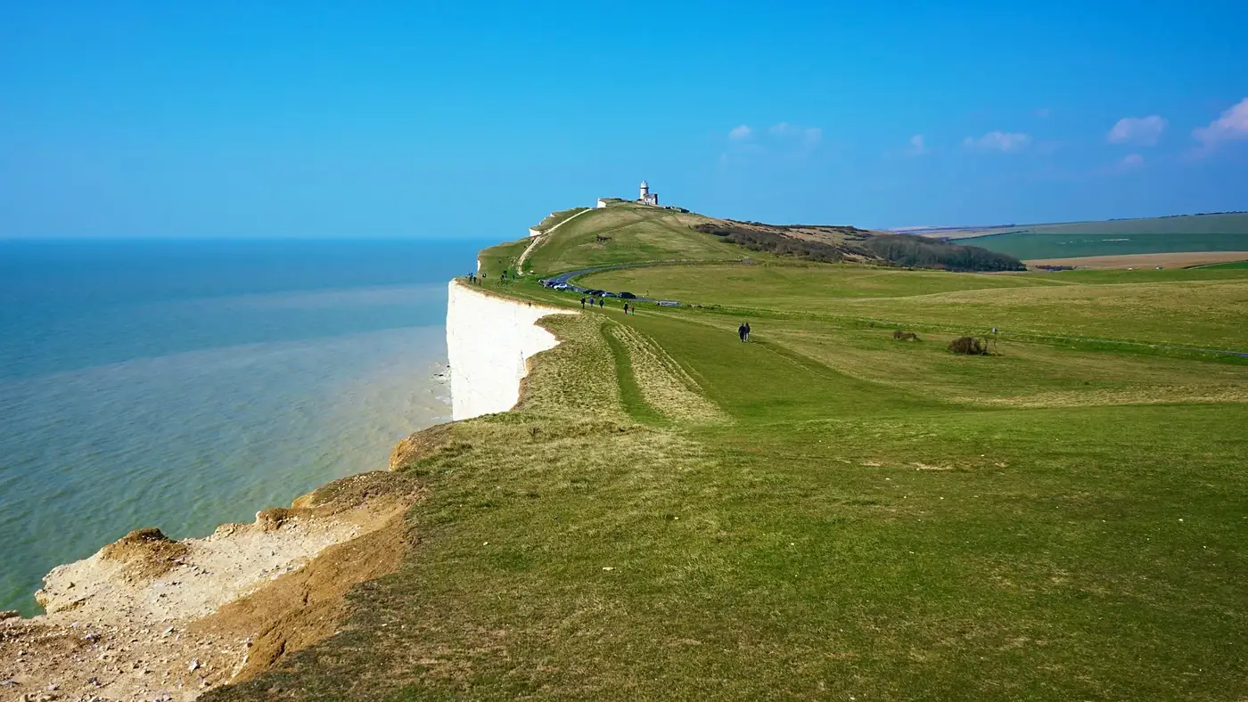 Experience the breathtaking cliffs and seashore near Eastbourne, England on a sunny summer day.