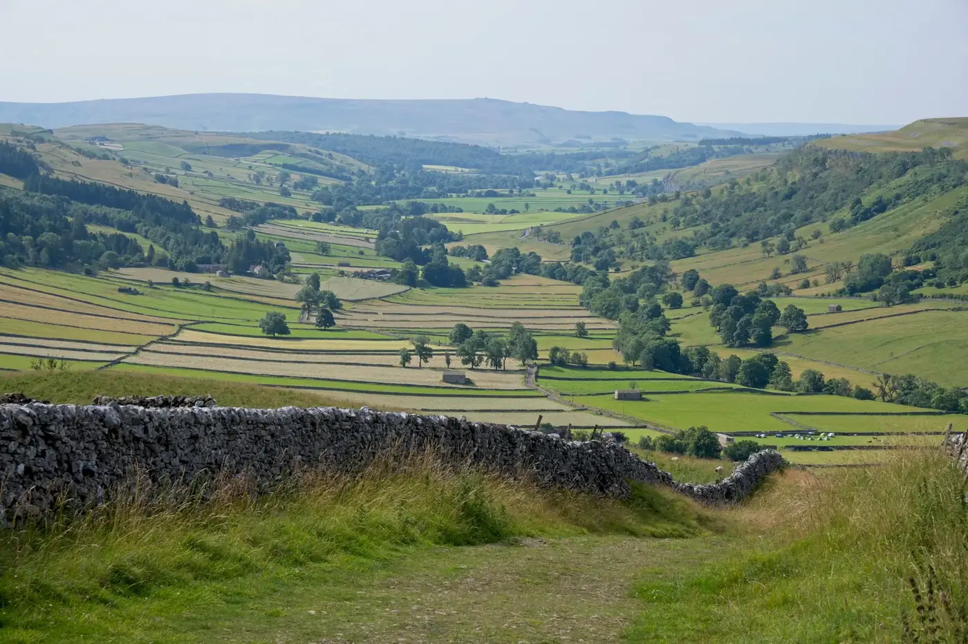 Breathtaking view of rolling hills and fields in England's picturesque countryside.