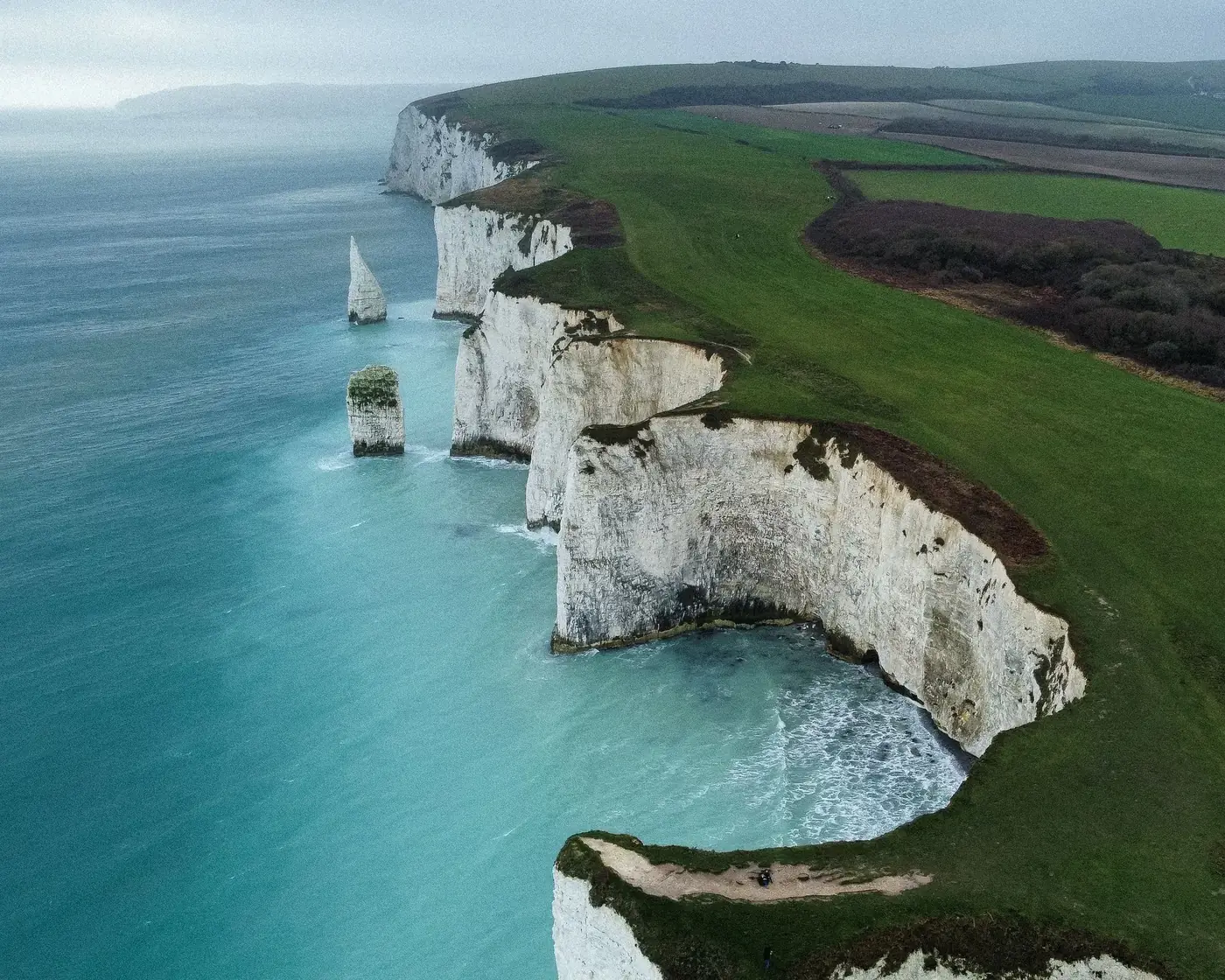 Stunning aerial view of the white chalk cliffs along the UK's southern coastline. Captivating nature scene.
